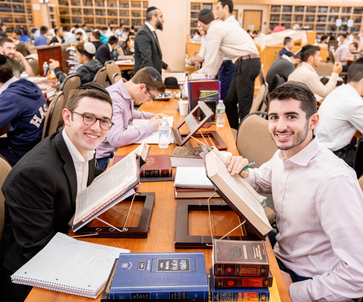 Day program students smiling while reading torah