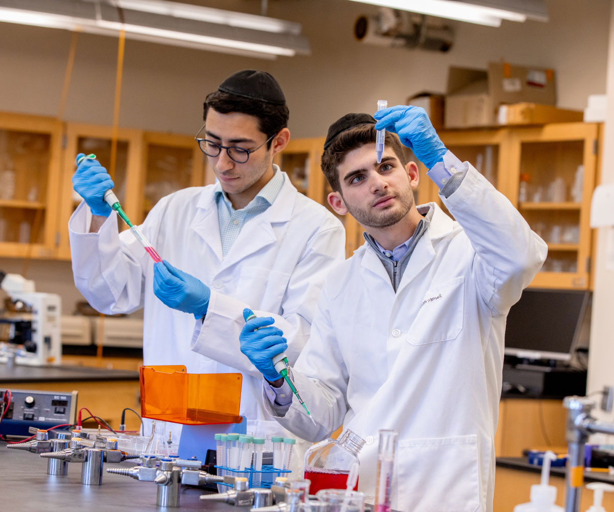 Two students working with liquids in lab