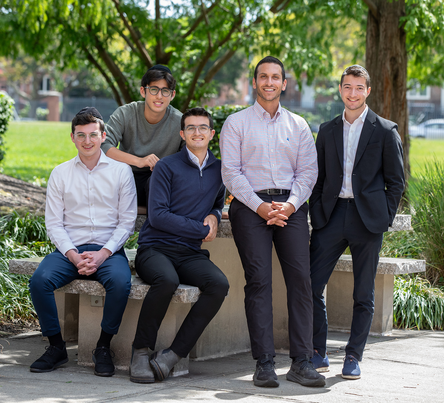 Group of LCM students standing and sitting in a park together