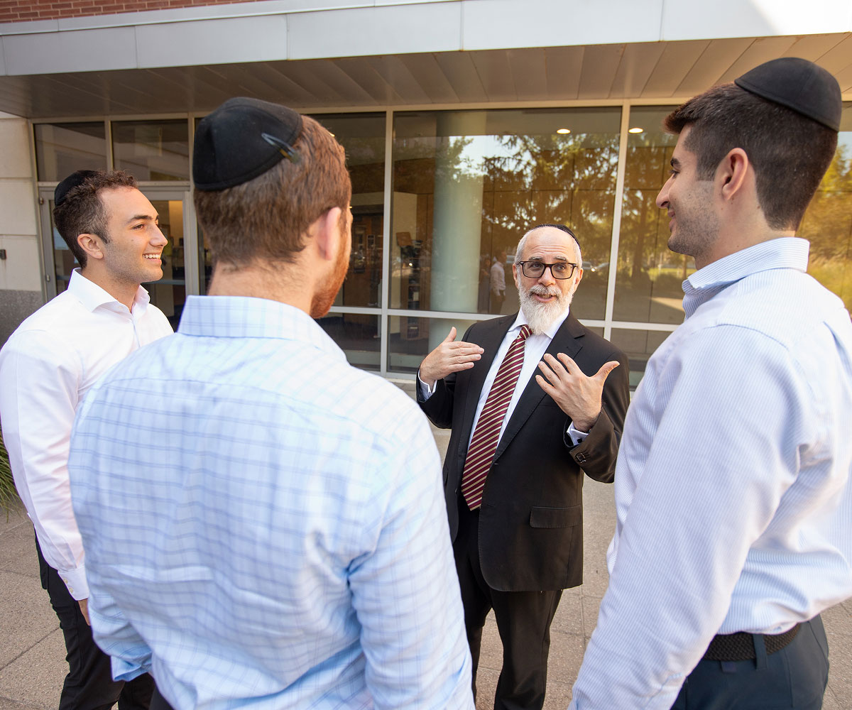 Group of LCM students talking with the dean